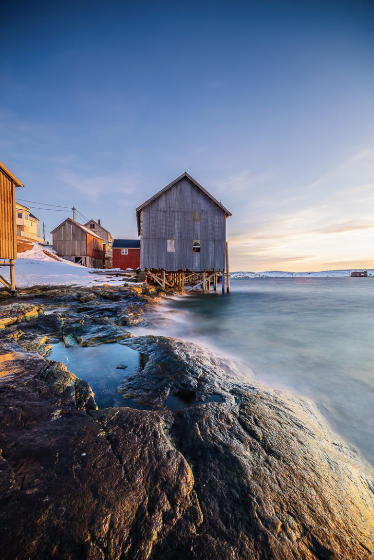 The winter light plays with the boat house and warehouse walls in Træna © Arvids Baranovs